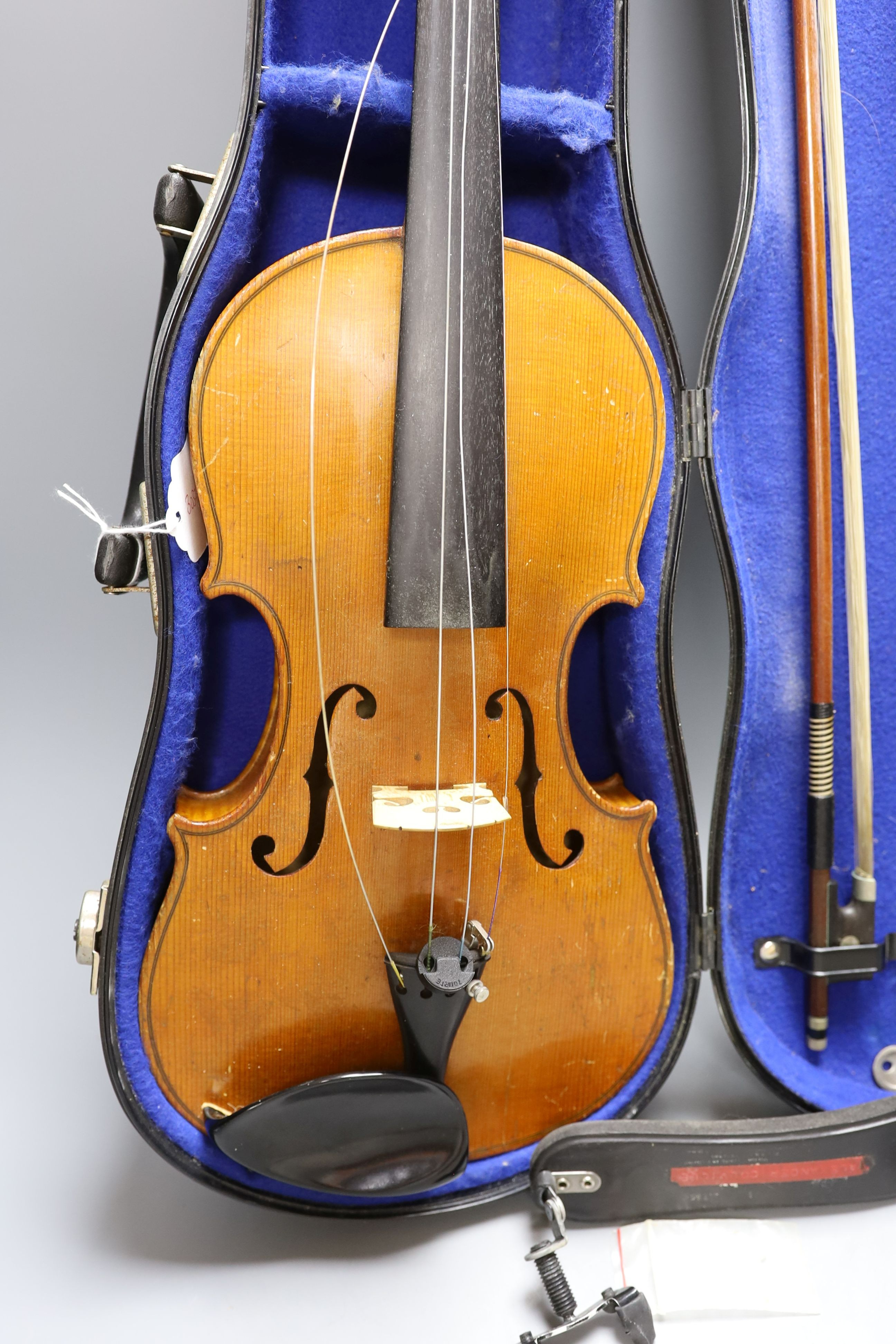 A 20th century violin in case with two bows, length of back 35.5cm